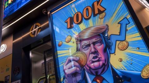 A cartoon image of Donald Trump holding a bitcoin displayed at a Coinhero store in Hong Kong.