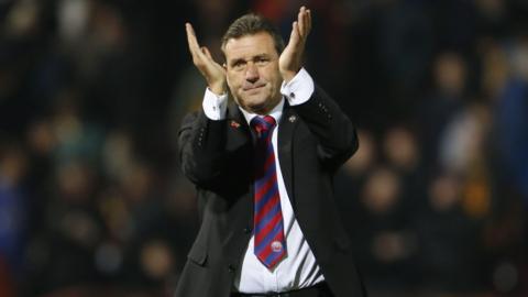 Aldershot Town boss Tommy Widdrington applauding supporters