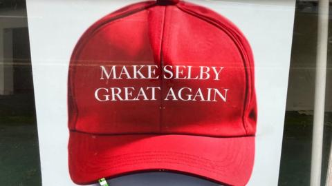 A red baseball cap with the inscription Make Selby Great Again on the front