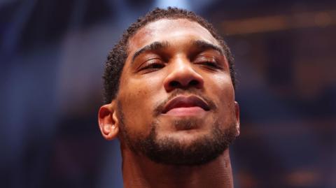 Anthony Joshua smirks after a fight