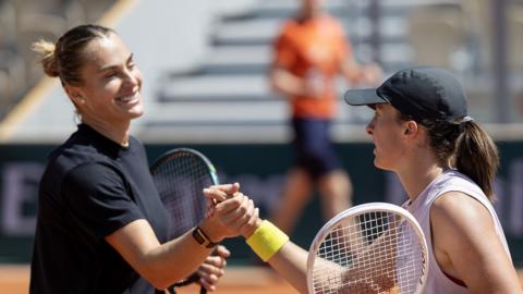 Aryna Sabalenka and Iga Swiatek shake hands after a French Open practice