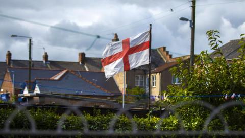 An flag of St George flying in someone's backgarden