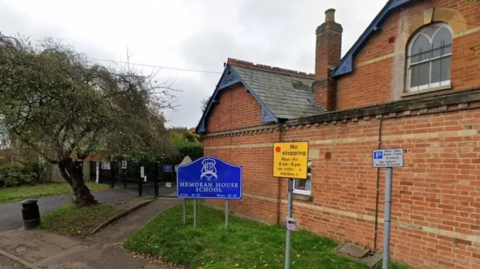 A Google Maps general view picture of the school site, a two-storey brick building on the side of a residential road.