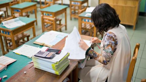 A stock image of a teacher marking work