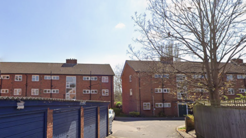 Flats behind blue garages