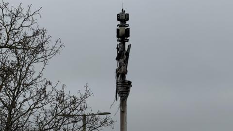 Burnt telephone mast next to the A40.