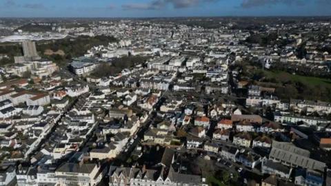 Streets, houses and rooftops in Jersey as seen from above.