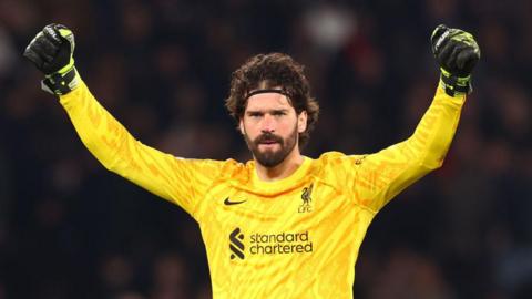 Alisson celebrates after Liverpool beat PSG