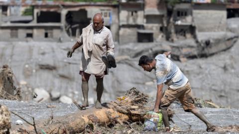 A flood survivor returns to home following a flash flood in Devighat Village, Nuwakot district, Nepal, 27 August 2026.