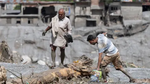 A flood survivor returns to home following a flash flood in Devighat Village, Nuwakot district, Nepal, 27 August 2026.