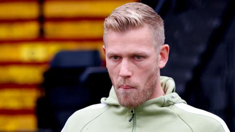 Port Vale's Jayden Stockley in a light green club hoodie is arriving for a match