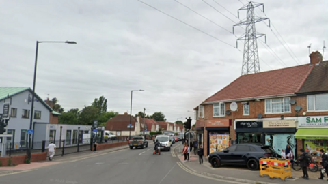 A Google Maps picture of Stoke Road in Slough, with a parade of shops on the right side.
