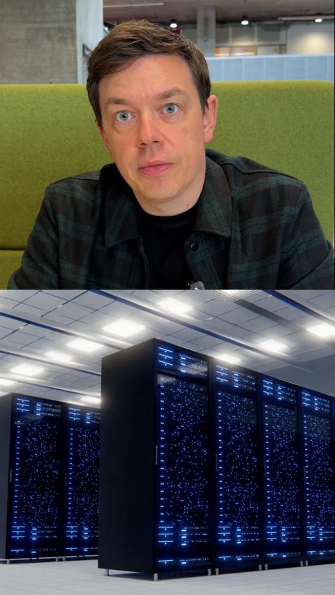 A man looking at the camera, with a line of computer servers below him