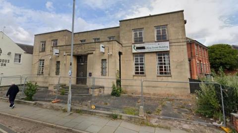 The two-storey King Street building closed off by grey fencing