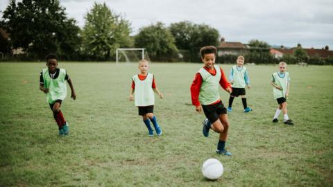 Young boys playing football