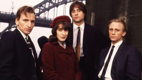Christopher Eccleston, Gina McKee, Mark Strong and Daniel Craig as their characters, standing in front of the bridge across the Tyne.
