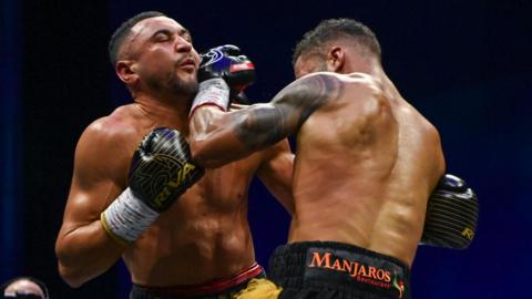 Callum Simpson is punched by Troy Williamson