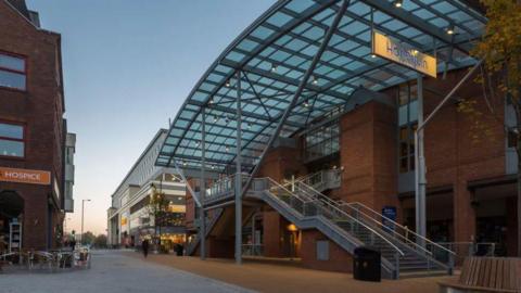 A wide shot of stairs leading up to the entrance of The Harlequin Theatre in Redhill.