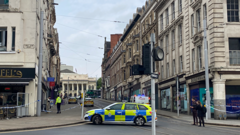 Police cars and a cordon in place in Market Steet, Nottingham