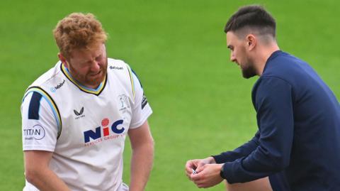 Yorkshire's Jonny Bairstow receives treatment for an injury