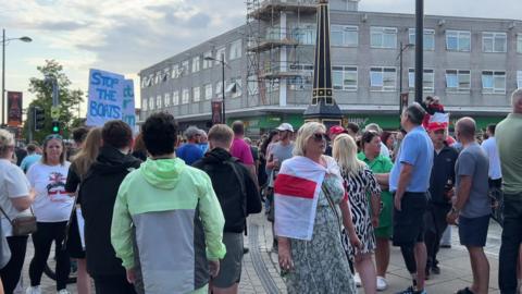 Crowds of people gathered in the streets of Waterlooville, one woman can be seen wearing a st george's cross flag