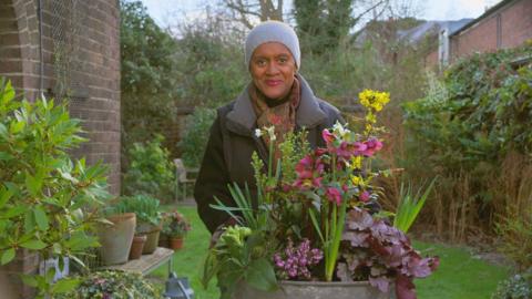 Arit from Gardeners' World with a colourful sprong container