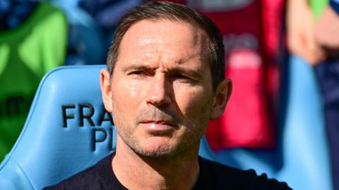 Frank Lampard sat in the Coventry techincal area wearing a dark round-neck sweater