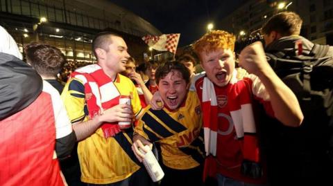 Arsenal fans celebrate outside the Emirates 
