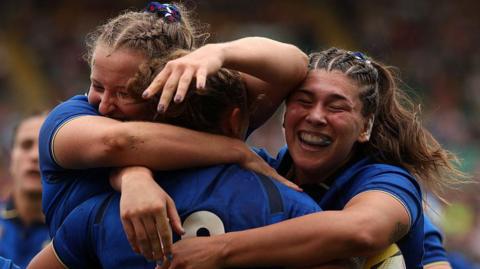 Italy players celebrate a try against Brazil