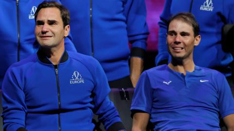 Roger Federer and Rafael Nadal cry, sat alongside each other