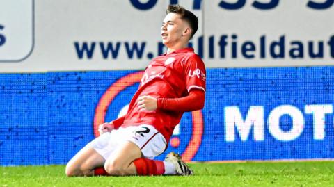 Patrick Kelly on his knees after scoring for Barnsley