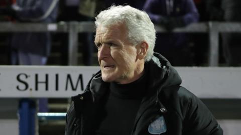 Mark Hughes watching Carlisle play Walsall