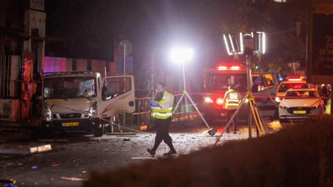 Israeli first responders inspect the scene of a bomb explosion in Tel Aviv, Israel, which Hamas says was a suicide attack (18 August 2024) 