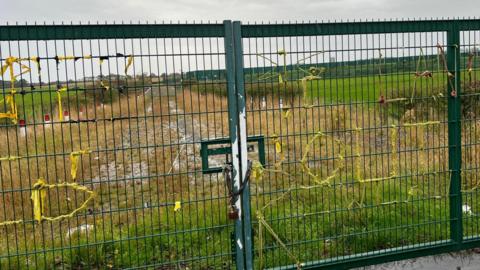 Overgrown with weeds and grass, the Preston New Road site lies behind padlocked large green metal gates. Yellow tape stuck on the gates by anti-fracking protestors years ago is starting to peel away