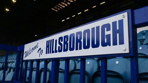 A sign on the front of a stand spelling out the words 'Welcome to Hillsborough'