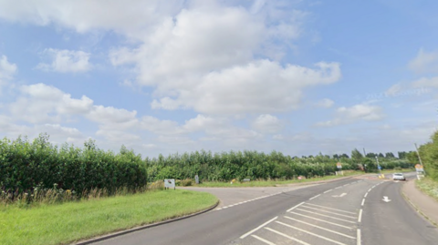A motorway with greeneries on the side of the road. 