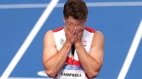 Evan Campbell with his head in his hands