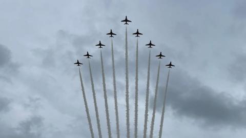 Red Arrow jets in triangular formation with white trails