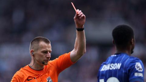 Match referee Michael Salisbury shows a red card to Ben Johnson