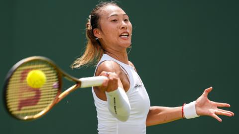 Zheng Qinwen hits a forehand at Wimbledon 2025