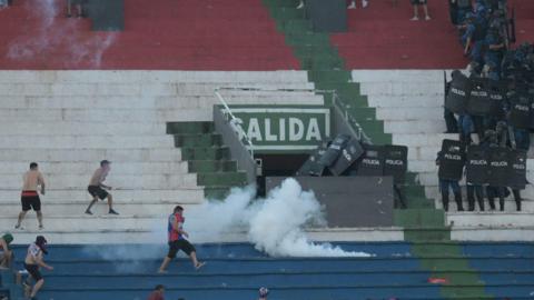 Police fire tear gas in an attempt to quell trouble during a game between Olimpia and Cerro Porteno in the Paraguay captial Asuncion.