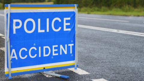 Police accident sign beside an empty road