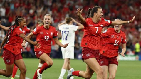 Switzerland's Riola Xhemaili celebrates scoring their first goal with Smilla Vallotto and Leila Wandeler