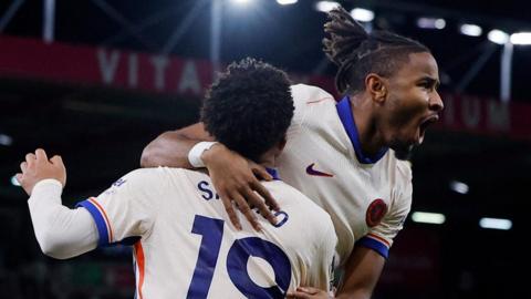 Christopher Nkunku and Jadon Sancho celebrate