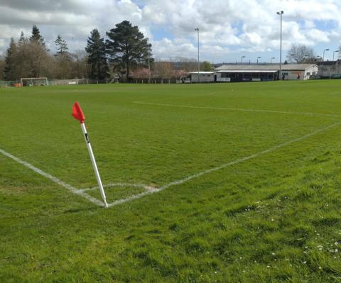 a football pitch with a red corner flag