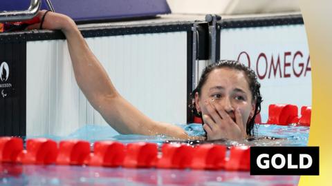 Alice Tai wins gold in the S8 100m backstroke.