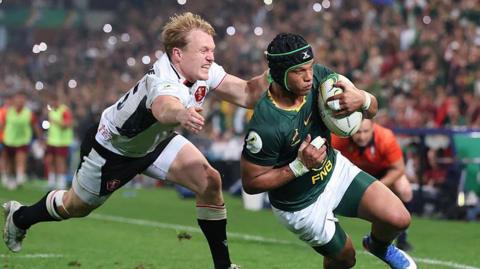 Kurt-Lee Arendse of South Africa goes past Blair Murray of Wales to score his team's sixth try