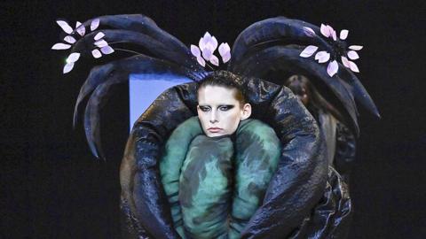 a model wearing a fun outfit with tussles on their head