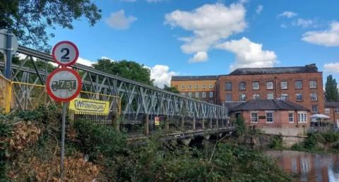 A footbridge over a river.