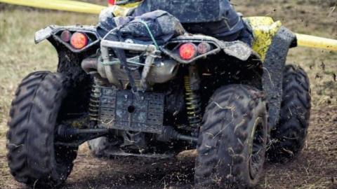 Close up of the rear of a quad bike on a dirt track